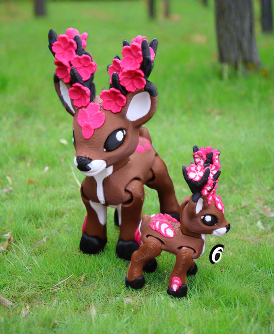 Toy deer with cherry blossom antlers on a natural background